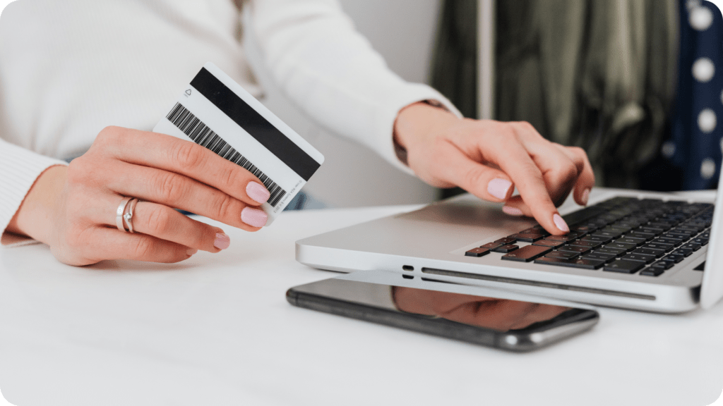 Woman holding a credit card while applying for a mortgage loan online